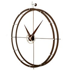 a clock that is hanging on the side of a wall with an arrow in it