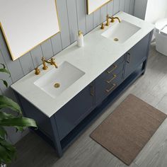 a bathroom with two sinks and a rug on the floor next to each other in front of mirrors