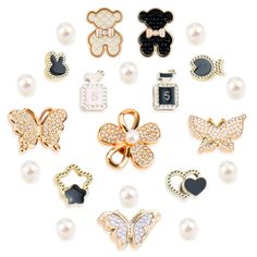 a bunch of different types of brooches and pins on a white background with pearls