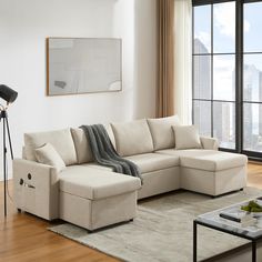 a living room with a sectional couch and coffee table in front of a large window