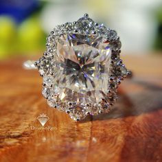 a diamond ring on top of a wooden table