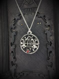 This Sigil of Sallos necklace is an handmade pewter sculpture with a gem of your choice (my favorite is the red abalone, if you are looking for a very nice bloody red) This seal of Sallos is one of the 72 Sigils of Goetia from Ars Goetia's Demonology This Sigil of Goetia pendant is sold with a free 18'' stainless steel chain, if you would like to have a different length for the chain, you can write the desired length in the private note section when ordering :) This Seal of Sallos is a pendant o Collectible Gothic Metal Necklace, Red Spiritual Metal Jewelry, Spiritual Red Metal Necklace, Red Sterling Silver Necklace With Oxidized Finish, Nickel-free Gothic Necklaces For Collectors, Gothic Nickel-free Necklaces, Nickel Free Gothic Necklaces For Collectors, Silver Brass Medallion Pendant Necklace, Red Symbolic Engraved Jewelry