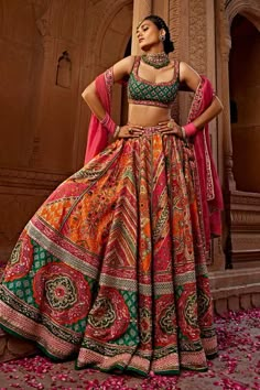 Orange, pink and green attached cancan lehenga with all over floral, mandala print, accentuated with heavy tassel strings with gota embroidery, hand adda work, beads and sequins embellishments. Paired with a padded blouse with all over quatrefoil print and sequin embellishments. Comes along with a dupatta with floral embroidered border.
Components: 3
Pattern: Print, Embroidery
Type Of Work: Floral, Mandala, Sequins, Beads
Neckline: Scoop Neck
Sleeve Type: Sleeveless
Fabric: Blouse and Lehenga: R A Line Lehenga, Choli Dress, Lehenga Dupatta, Lehenga Choli Online, Multi Color Blouse, Wedding Saree Indian, Designer Lehenga Choli, Chaniya Choli, Indian Wedding Outfits