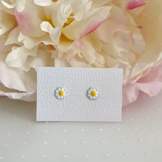 Dainty and delicate set of mini daisy stud earrings. Metal : 925 Sterling Silver. ( 925 stamped ) Weight : 0,45g. Measurements : 9mm x 7mm. (aprox) Material : Enamel. These delicate stud earrings are handcrafted from 925 sterling silver, that doesn't tarnish their little ears also hypoallergenic and nickel free. PACKING: All jewelry is package already to be gifted. Just let me know if the gift is for a birthday, I will add some fun birthday confetti! Also you have the opportunity to add a person Tiny White Sterling Silver Earrings, Tiny Sterling Silver Flower Earrings As Gift, Dainty Hypoallergenic Flower Earrings, Tiny White Dainty Flower Earrings, Dainty White Sterling Silver Flower Earrings, Dainty White Birth Flower Earrings, Tiny White Earrings For Gift, Cute Hypoallergenic Silver Flower Earrings, Cute Silver Flower Shaped Earrings