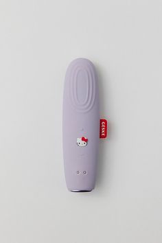 a purple object with a hello kitty sticker attached to it's side on a white surface