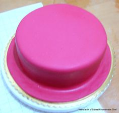 a pink cake sitting on top of a white plate