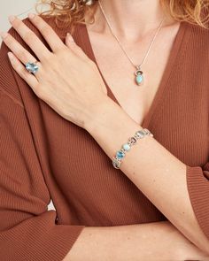 Handcrafted in sterling silver, the Hummingbird Stone Link Bracelet features a unique blend of links and criss-cross flat rope chains connected with petroglyph-textured stations. The links showcase a combination of rectangular faceted stones, including a Hampton blue topaz, blue topaz, and moonstone, along with a rounded larimar cabochon, and is completed with a replica of the iconic St. John petroglyph. Metal: Sterling Silver Stones: Hampton blue topaz, larimar, blue topaz, moonstone Band Width Sterling Silver Gemstone Bracelet, Fusion Style Silver Jewelry With Blue Topaz, Sterling Silver Bracelet With Gemstone, Silver Topaz Jewelry With Polished Finish, Elegant Jewelry With Blue Topaz And Natural Stones, Elegant Blue Topaz Jewelry With Natural Stones, Elegant Blue Topaz Jewelry With Stones, Elegant Blue Topaz Stone Jewelry, Turquoise Topaz Jewelry With Gemstone Accents