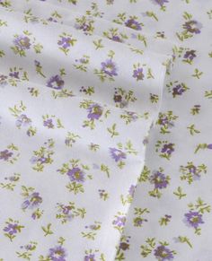 purple and green flowers on white fabric