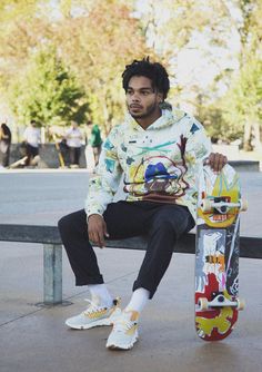 a young man sitting on a bench holding a skateboard in his hand and looking at the camera