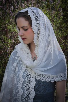 A veil in honor of Our Lady of Guadalupe. An incredibly soft veil. This is a lovely and soft fabric, strewn with lovely embroidered flowers. The delicate flowers are scattered over the entire veil, and the edge is scalloped gently around the face. Finished with an intricate Venice trim at the hem. Wrap it in several ways, or wear it down, and as a shawl. This generously-sized tapered rectangle veil measures about 70 x 24 inches. Evintage veils are handmade in limited production; not mass produce Elegant Wedding Dupatta With Lace Trim, Cream Lace Wedding Veil, White Bohemian Wedding Dupatta, White Bohemian Dupatta For Wedding, Bohemian White Dupatta For Wedding, Elegant Dupatta For Wedding, Elegant Dupatta For Marriage, Elegant White Dupatta For Marriage, Vintage Lace Wedding Veil