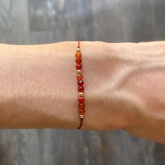 W E L C O M E  T O  [  T I M E + S P A C E  ] 🪐  Elevate your vibration with this handmade minimalist red silk string bracelet featuring 2-3mm gold filled and healing crystal beads:- 💎 C A R N E L I A N   =  ( energy ) Designed as a manifestation bracelet with no closure, to be tied and worn continuously until the cord eventually wears away. However, there is an option to include an adjustable gold filled sliding bead.  📏 Length: 30cm to fit all wrists (please add comments to customise length Adjustable Carnelian Beaded Bracelets As Gift, Adjustable Carnelian Bracelet As A Gift, Adjustable Carnelian Bracelet Perfect For Gifts, Adjustable Carnelian Beaded Bracelets For Meditation, Gold Gemstone Beads Friendship Bracelets For Gift, Gold Friendship Bracelets With Gemstone Beads As A Gift, Gold Friendship Bracelets With Gemstone Beads, Adjustable Gold Carnelian Beaded Bracelets, Gold Carnelian Beaded Bracelets For Spiritual Wear