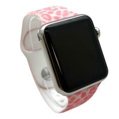 an apple watch with pink and white flowers on the band, is seen in this image