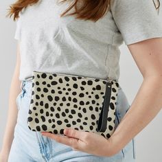 Our Cheetah Print Leather Clutch Bag is the perfect touch of sophistication to any outfit. Featuring a  secure YKK zippered closure that keeps your belongings safe and secure. The perfect small purse size for your phone, lipstick, and other small essentials. Each bag is handmade with care, meaning that every clutch is unique and one-of-a-kind. It also comes with a detachable wrist strap that is fastened with a lobster clip - for easy removal when you are wanting to have a handheld small clutch bag option. One side is made from high quality hair on hide leather and the other side will be a smooth black leather. Please note that the hair on hide is textured, meaning that it may be longer on certain sections of the bag than others, this is not to be considered a fault.   We also offer a match Chic Bags With Zipper Pouch For On-the-go, Trendy Pouch Clutch For Errands, Daily Use Clutch Shoulder Bag With Zipper Closure, Daily Use Shoulder Bag Clutch With Zipper, Daily Use Zipper Closure Clutch Shoulder Bag, Chic Leopard Print On-the-go Bag, Trendy Cosmetic Pouch, Trendy Pouch With Zipper Pocket, Trendy Handheld Bag With Zipper Pouch