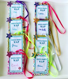 four diy party favors with ribbons and tags attached to them on a white tray