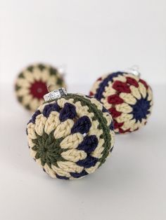 two crocheted ornaments sitting on top of each other