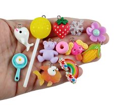 a hand holding a bunch of small toy items