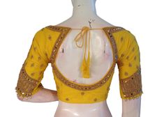 Make a Statement With this yellow color semi silk blouse, adorned with intricate Aari hand embroidery! This stunning piece combines traditional Indian techniques with modern style. Perfect for special occasions or adding a touch of elegance to your everyday look. * This Is A Fully Stitched Saree Blouse, Ready To Wear * Made of Semi silk, Lined With Cotton * Opens From Front With Hook and eye-fitting MEASUREMENTS: Sleeve: 10 inches  Size: 38,40,42 Blouse Length: 15.5 inches  Neck depth: 7 inches Yellow Semi-stitched Elegant Blouse Piece, Elegant Yellow Blouse With Cutdana, Elegant Semi-stitched Yellow Blouse Piece, Elegant Designer Yellow Blouse Piece, Elegant Yellow Semi-stitched Blouse Piece, Yellow Blouse For Transitional Wedding Season, Transitional Season Yellow Blouse, Yellow Silk Choli With Cutdana Detail, Elegant Yellow Blouse With Resham Embroidery