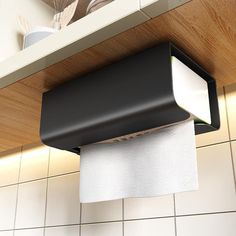 a roll of toilet paper hanging from the ceiling above a kitchen counter with utensils