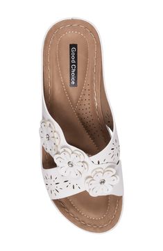 Floral appliqués and laser-cut details add visual intrigue to a slide sandal lifted by a subtle platform and wedge heel. 2 1/2" heel; 1 1/4" platform Memory foam cushioning with arch support Synthetic upper and lining/rubber sole Imported White Wedge Sandals With Arch Support, Closed Toe Synthetic Slides, White Slide Wedge Sandals For Spring, Ortholite Insole Slides With Flat Heel, White Platform Slide Wedge Sandals, White Open Toe Heels With Arch Support, White Open-toe Heels With Arch Support, White Cushioned Slide Wedge Sandals, Platform Wedge