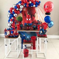 a spiderman birthday party with balloons and decorations