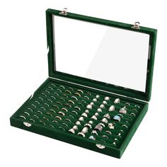 an open green box with lots of rings in it