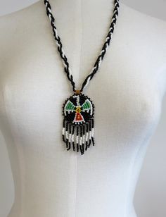 Vintage Navajo Wedding Basket Thunderbird Design Glass Beads Necklace Pendant. Backed by leather. Dimensions of necklace: Width 50mm (2") Height 75mm (3" including drops) Length 24" Please check out my other designs and vintage pieces here: https://www.etsy.com/uk/shop/YouGotTheSilverUK  Click on customise for any custom queries or bespoke pieces. Adjustable Medallion Beaded Necklaces For Festivals, Bohemian White Jewelry With Black Beads, Southwestern Necklaces With Dangling Beads And Adjustable Fit, Southwestern Necklaces With Dangling Beads, Southwestern Necklace With Dangling Beads And Adjustable Fit, Southwestern Style Adjustable Teardrop Necklace, Southwestern Festival Jewelry With Large Beads, Southwestern Style Large Beads Jewelry For Festivals, Southwestern Style White Jewelry With Dangling Beads