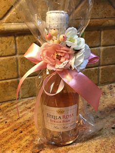 a wine bottle wrapped in plastic and tied to a counter top with flowers on it