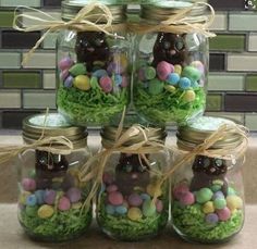 mason jars filled with easter eggs and grass