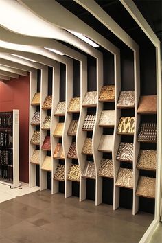 a room filled with lots of different types of floor coverings and shelves full of books