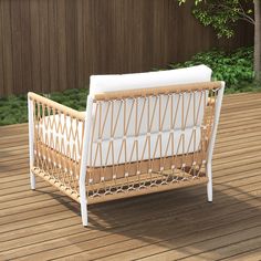 a wicker crib sitting on top of a wooden deck