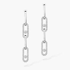 These Move Link diamond earrings in white gold can be transformed to suit any occasion. The bottom part detaches in an instant, allowing you to play with your look: a simple hanging style for everyday wear, a long version for even more sparkle in the evening, or an asymmetrical style for all-out originality. Mix and match, dare to invent your own style. The detachable links will also enhance your neck as a pendant, to be worn on a cord or chain.
 Move Link is a jewelry collection with character: Modern White Gold Diamond Dangle Earrings, Modern White Gold Linear Earrings With Diamond Accents, Modern Platinum Diamond Earrings In White Gold, Modern White Gold Diamond Drop Earrings, Messika Earrings, Gold And Diamond Earrings, Beyond The Lights, Logo Monogramme, Asymmetrical Style