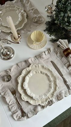 the table is set with dishes and silverware