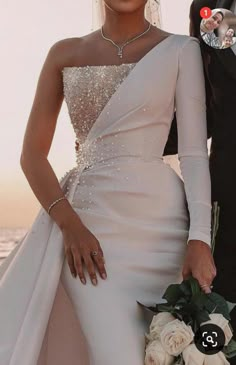 the bride and groom are posing for a photo