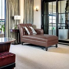 a living room filled with furniture and windows