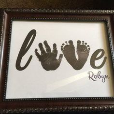 a frame with two handprints and the word love in it