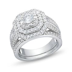 a white gold ring with diamonds on the sides and a square shaped diamond in the center