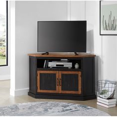 a flat screen tv sitting on top of a wooden cabinet