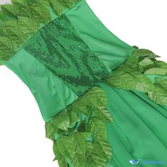 a green dress with leaves and sequins on it