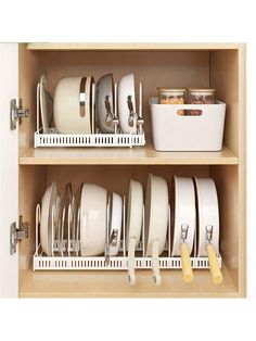 two shelves filled with dishes and pans next to each other