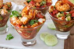 three small glasses filled with shrimp and salsa