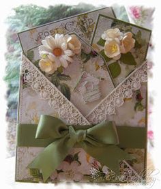 a close up of a greeting card with flowers and lace on the front, tied in a bow