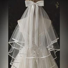 a white veil on top of a wedding dress