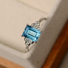 This ring features a 6*8mm emerald cut Swiss blue topaz and sterling silver finished with rhodium. Customization is available. It is made by hand, and it will take about 7 days to finish the ring after your payment is completed. Main stone: Swiss blue topaz Main stone weight: Approx 1.90 ct Metal type: sterling silver finished with rhodium Accent stone: cz Customization is available, I also can make it with 14k solid gold (white or yellow or rose) and diamond accent stone, just feel free to cont Jewerly Ring, Antique Rings Vintage, Swiss Blue Topaz Ring, Blue Topaz Jewelry, Sparkly Ring, Blue Diamond Ring, Topaz Jewelry, Gold Rings Fashion, Swiss Blue Topaz