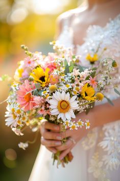 a bride holding a bouquet of flowers in her hands and looking at the camera with sunshine shining on her face