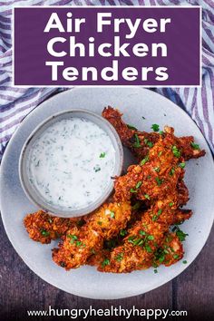 air fryer chicken tenders on a white plate with ranch sauce and parsley