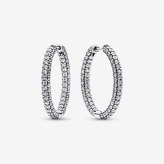 Classic hoops get a sparkling update in the Pandora Timeless Pavé Single-row Hoop Earrings. These sterling silver hoop earrings feature a D-shaped profile covered in pavé. Set with 198 round bead-set stones, these hoops will make any look shine. Peek inside to see the iconic Pandora logo engraved on the hoops' interior. Elevate your day-to-day style with these statement hoops or pair them with other sparkling pieces for a high-impact evening look. - Pandora Timeless Pavé Single-row Hoop Earrings - Sterling silver / Cubic Zirconia / Clear Pandora Logo, Sterling Silver Hoop Earrings, Sterling Silver Hoops, Lab Created Diamonds, Pandora Jewelry, Silver Hoops, Silver Hoop Earrings, Accessories Earrings, Round Beads