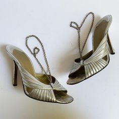 Authentic vintage early 2000s Givenchy metallic silver high heel sandals have beautiful raised curves across the toe area and silvertone chain link slingbacks. Made in Italy.  These have been well loved - still a lot of life left with a some attention - overall wear to uppers and insoles as shown, deep scuffing mostly to the heels and to the toe are of insoles, light tarnish on the chains.  Marked a 37.5; look to be a 6.5-7ish but please compare with a pair of your own shoes for reference. 9 7/8 Vintage Silver Heels For Evening, Silver High Heels With Chain Strap, Silver Vintage Heels For Party, Givenchy Paris, Slingback Heels, Slingbacks, Silver Shoes, Slingback Heel, Heels Sandals