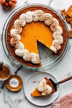 a pie sitting on top of a table next to other desserts and condiments