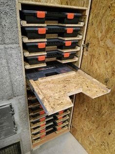 an open storage cabinet filled with lots of tools