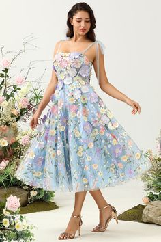 a woman wearing a dress with flowers on it